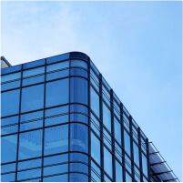 modern glass facade office building against blue sky