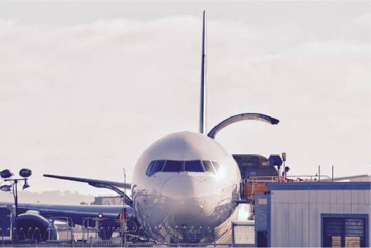 airplane being loaded with mail and packages